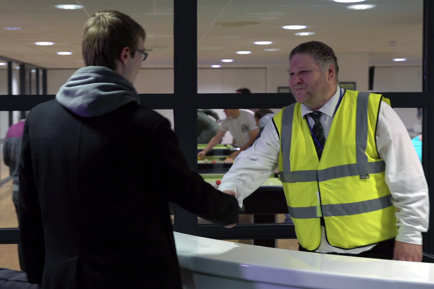 Security officer greeting student at CODE Student Accommodation Leicester