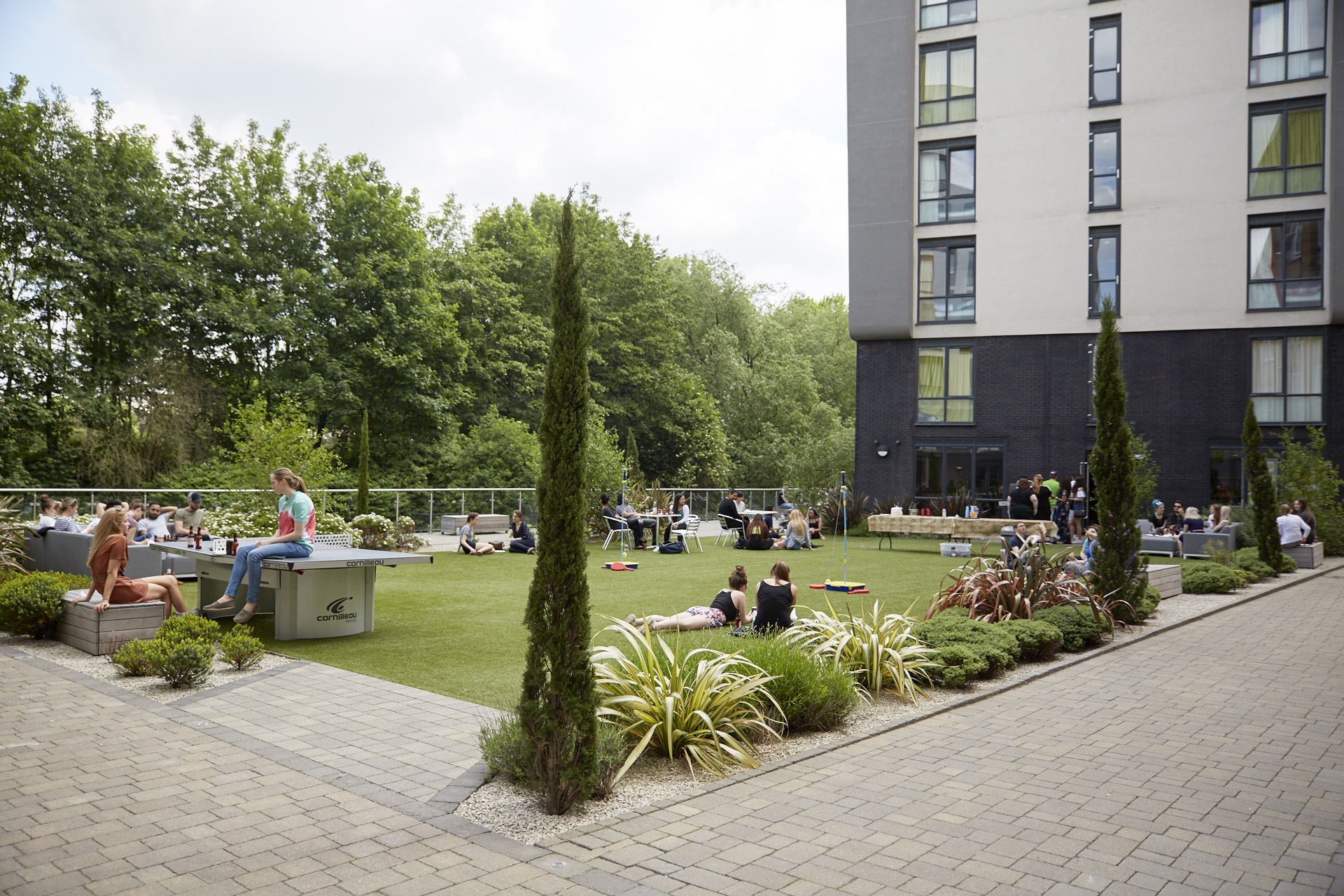 Students playing games in courtyard at CODE Student Accommodation Leicester