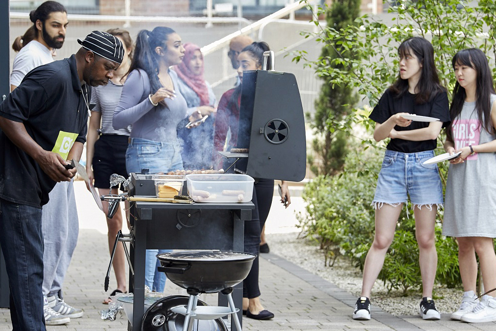 Students enjoying barbeque in the grounds of CODE Student Accommodation Leicester